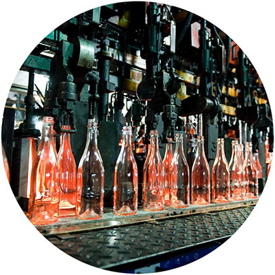 Bottle factory, row of hot transparent glass bottles