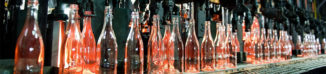 Bottle factory, row of hot transparent glass bottles